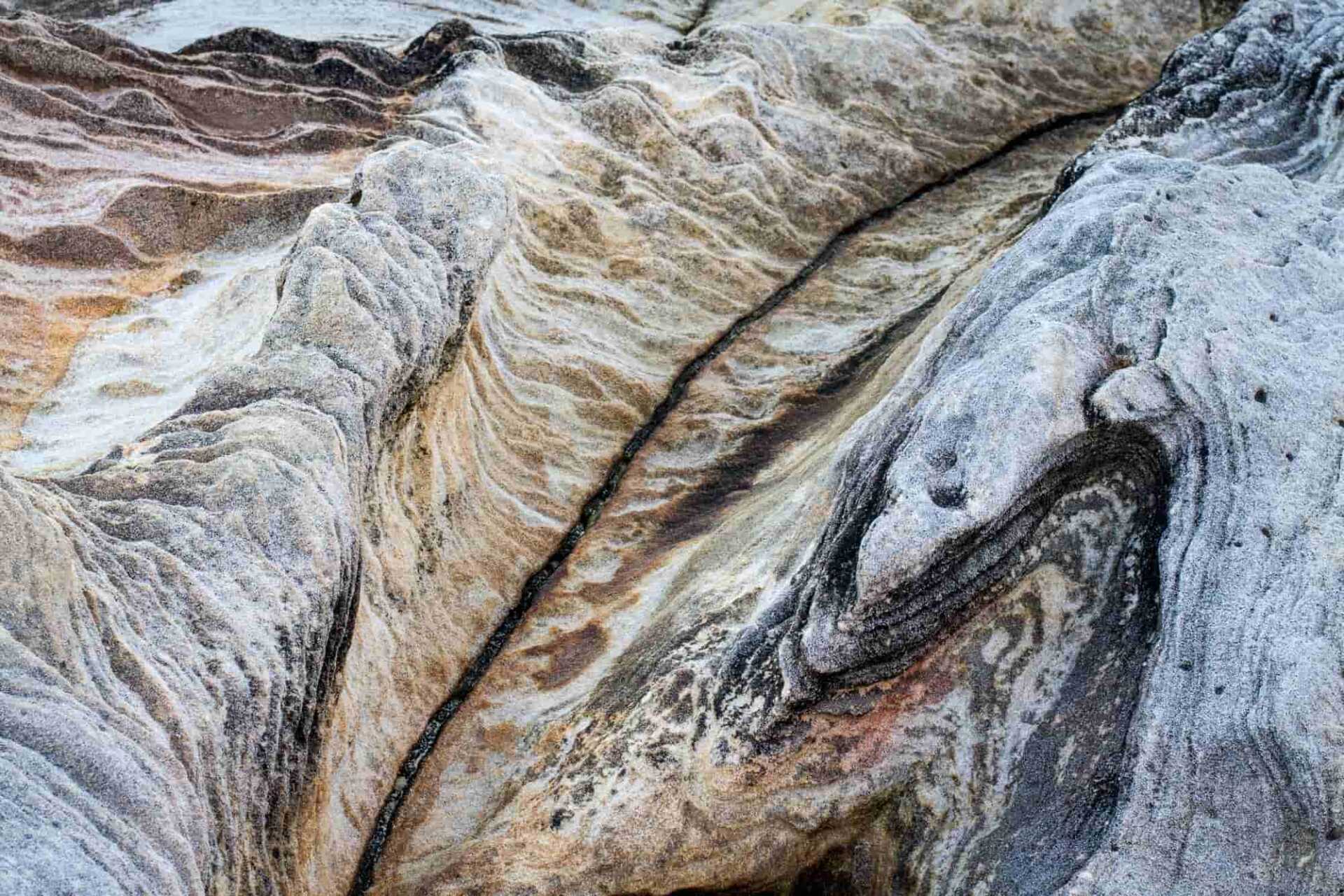 A closeup of swirling patterns on rock