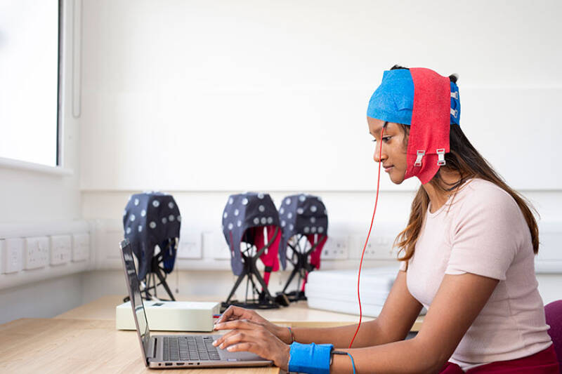 Female student using specialist equipment in Psychology lab