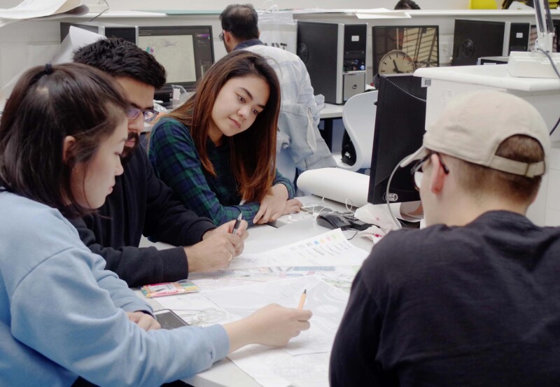 Students discussing a drawing plan