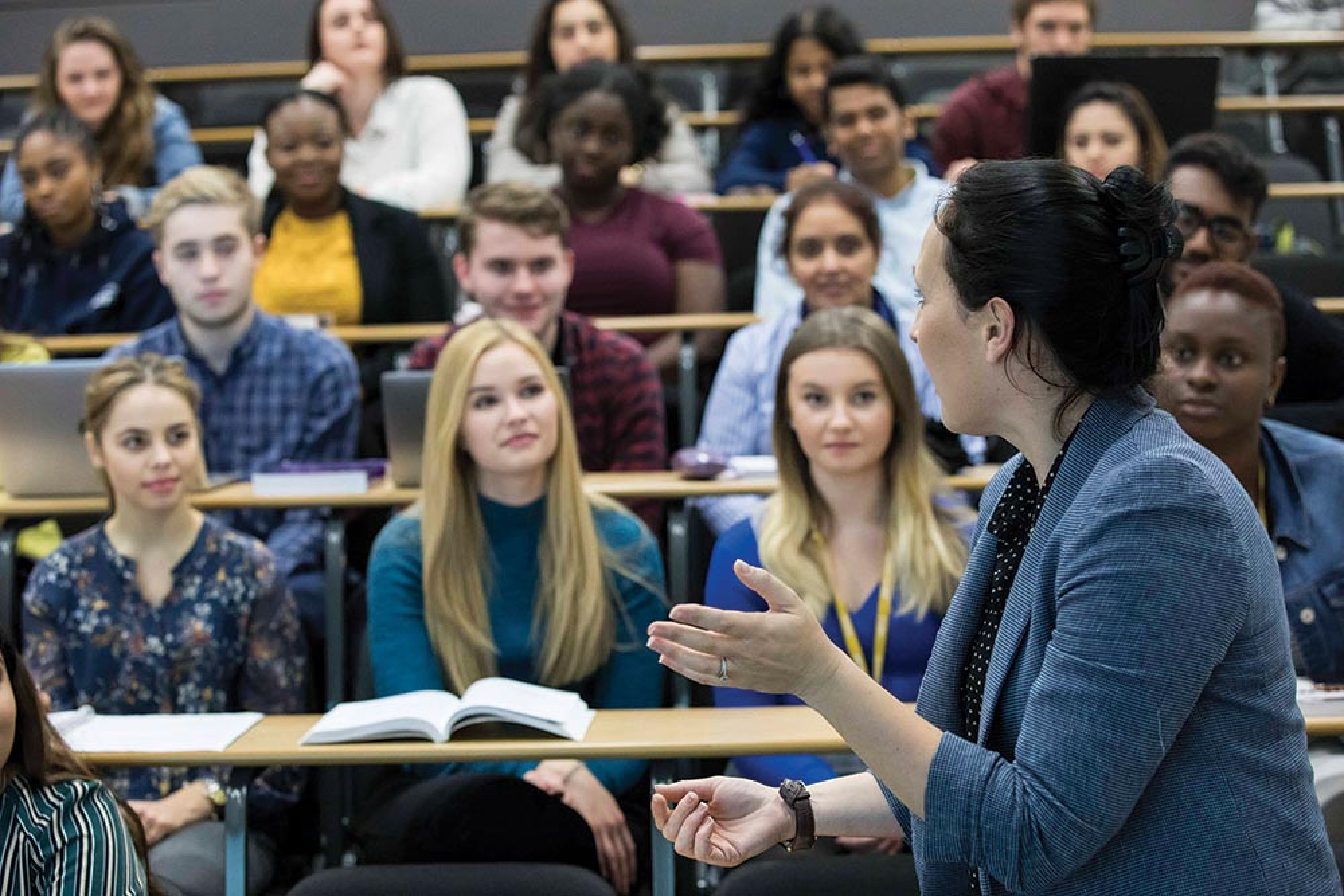 Lecturer talking to a full hall of students