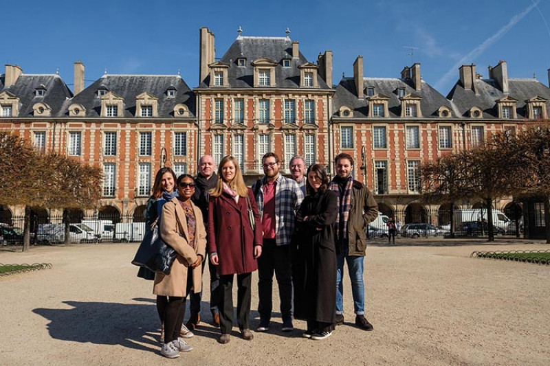 A group of students and lecturers posing in front of a pretty building in Paris.