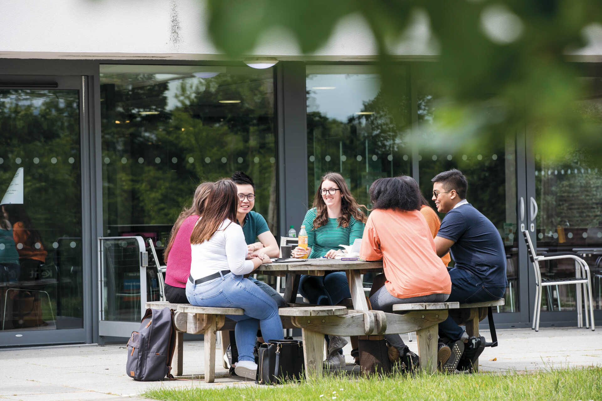 Students chatting on a bench