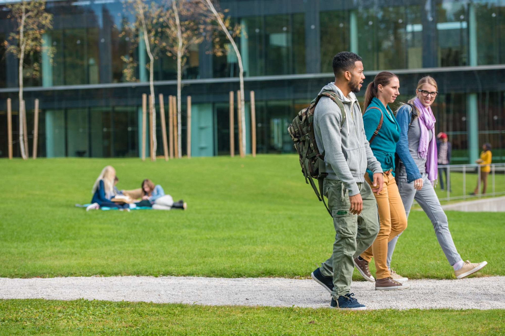 Three students walking around campus together