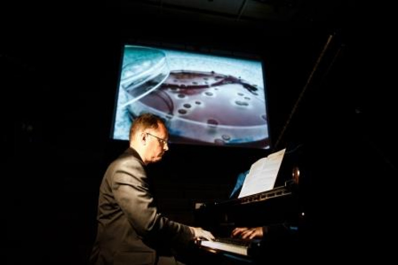 Pianist playing in front of projector screen