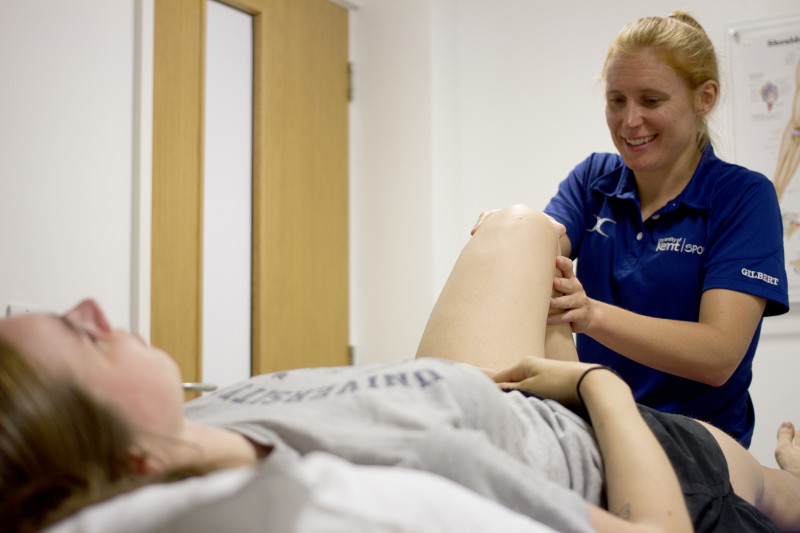 Vicky assessing a clients knee during an appointment