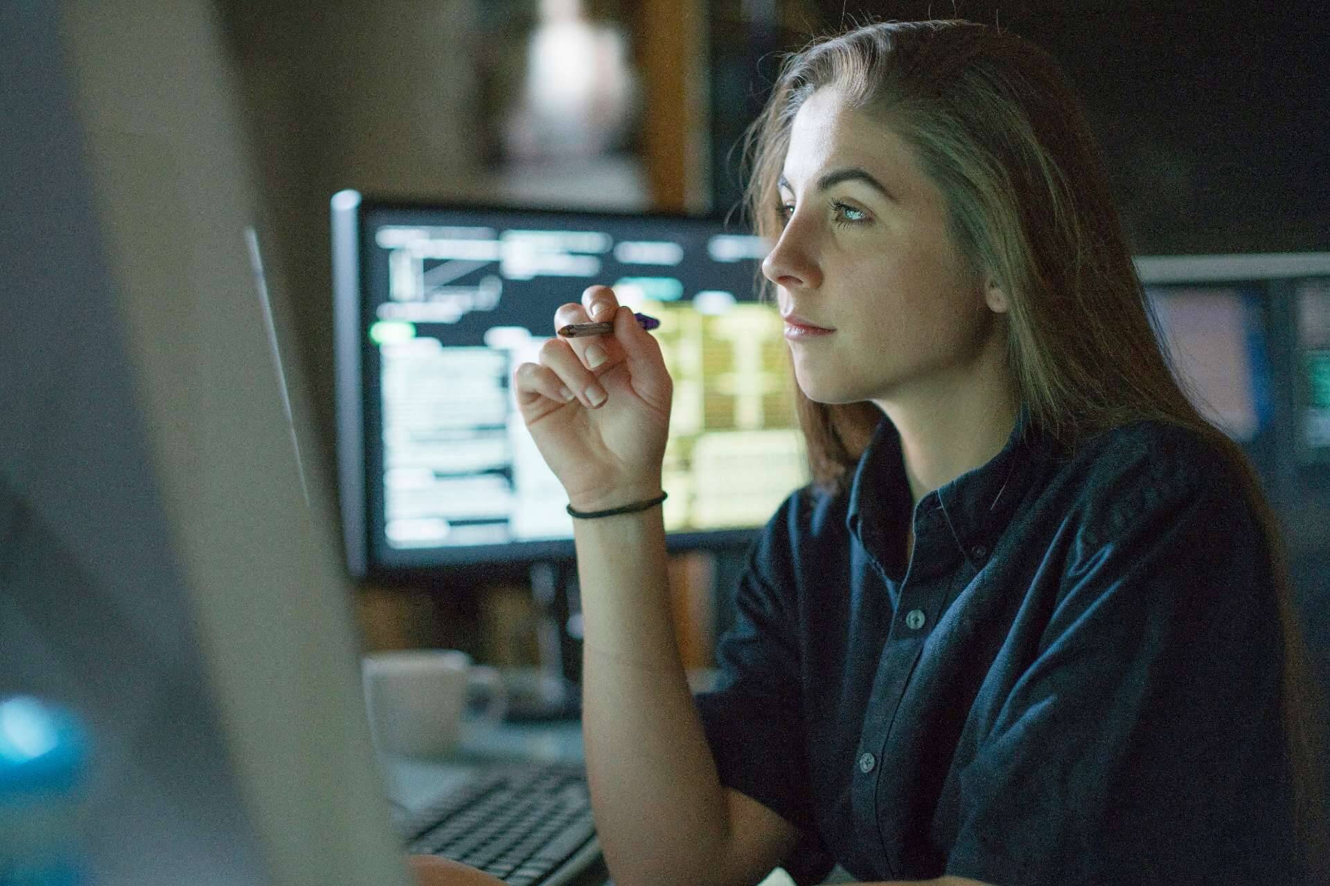 Woman at computer concentrating on screen