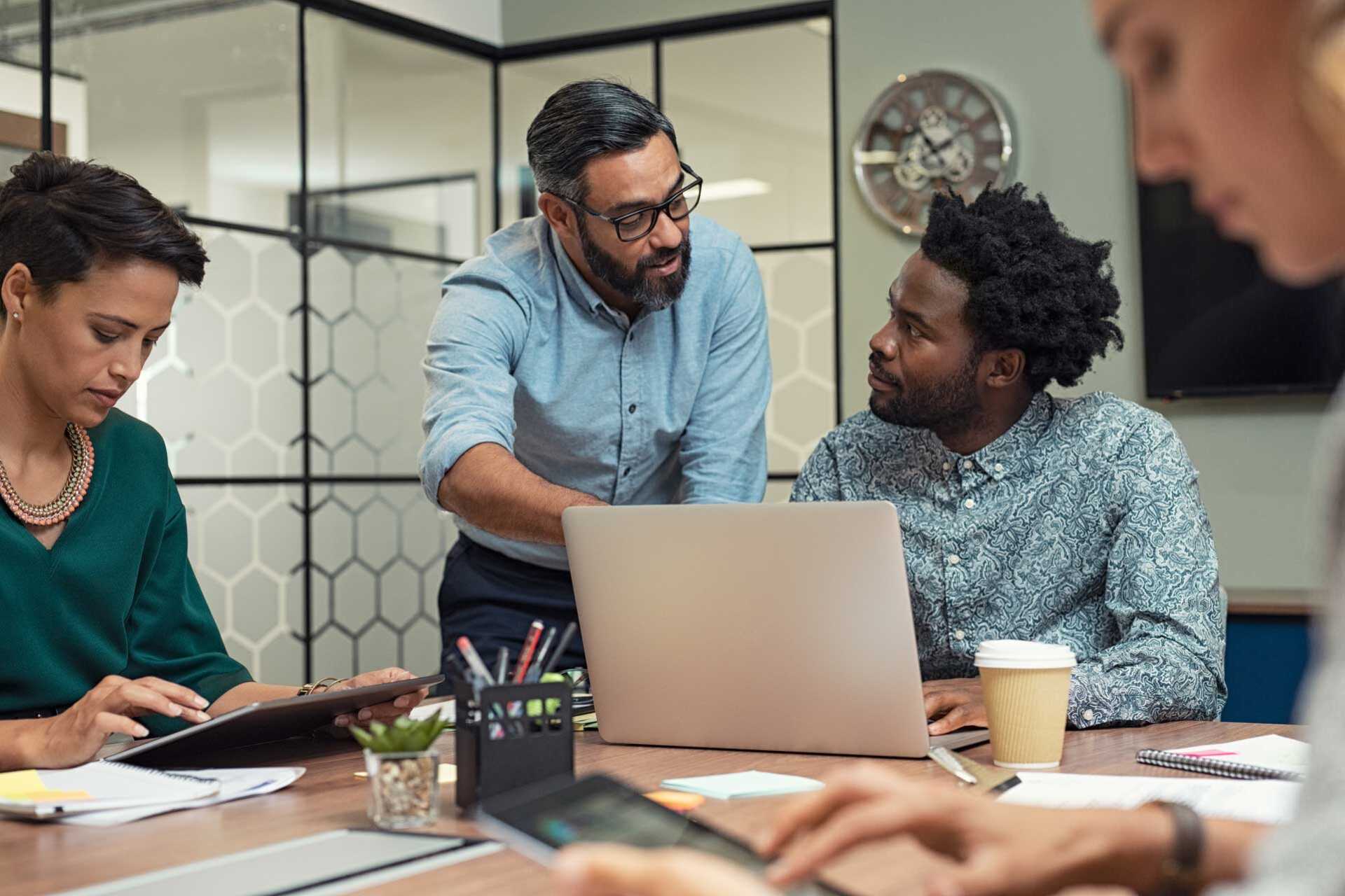 Three people working together at a computer