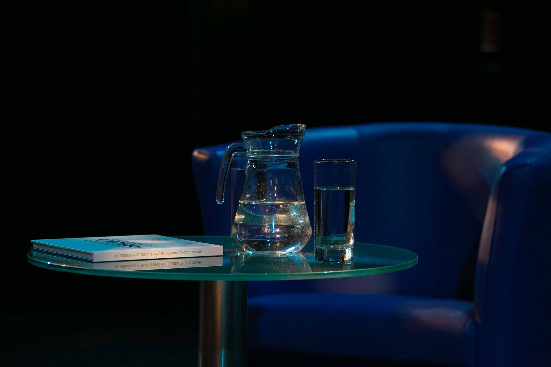 Table with a jug of a glass and jug of water on it
