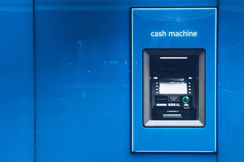 Cash machine on a blue wall