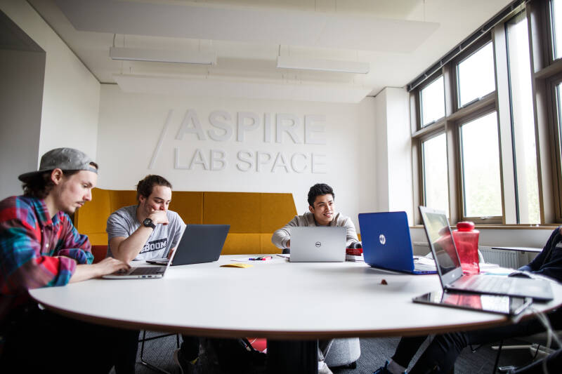 Students working in the Atrium of the Sibson Building