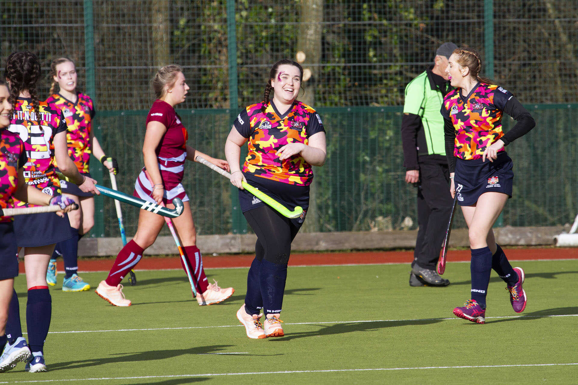 Male hockey player chasing the ball across the hockey pitch, wearing Team Kent kit