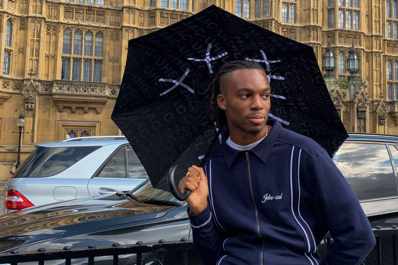 Emay Enemokwu holding umbrella