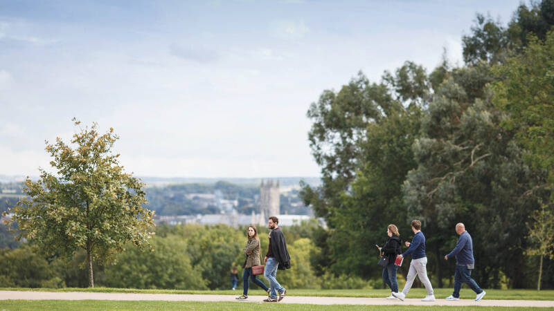Students walking across Canterbury Campus at the University of Kent