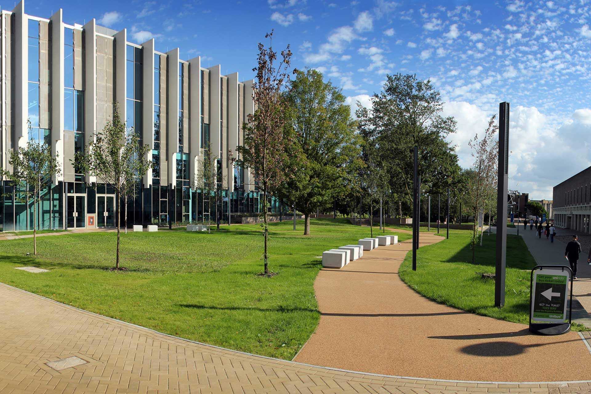 Green space with path and trees outside the Templeman Library