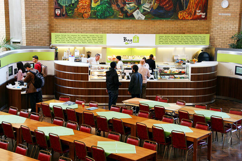 Bag It servery with customers and tables in foreground