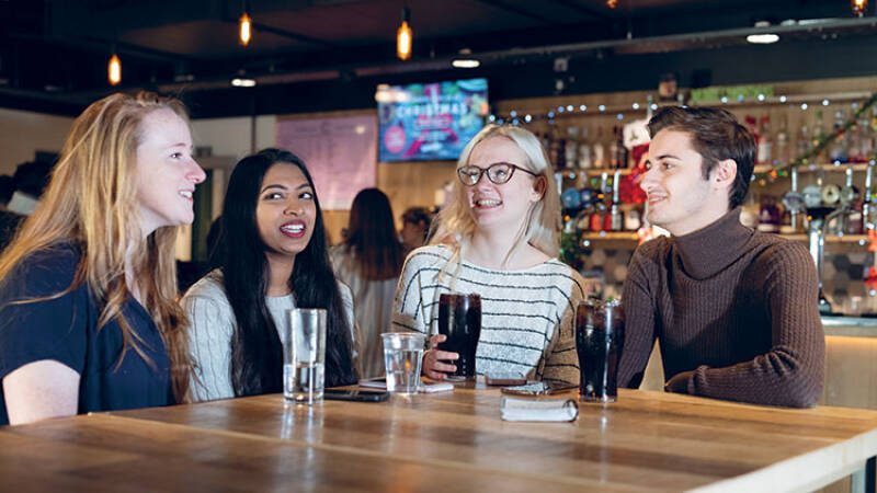 Students having a drink in Woody's