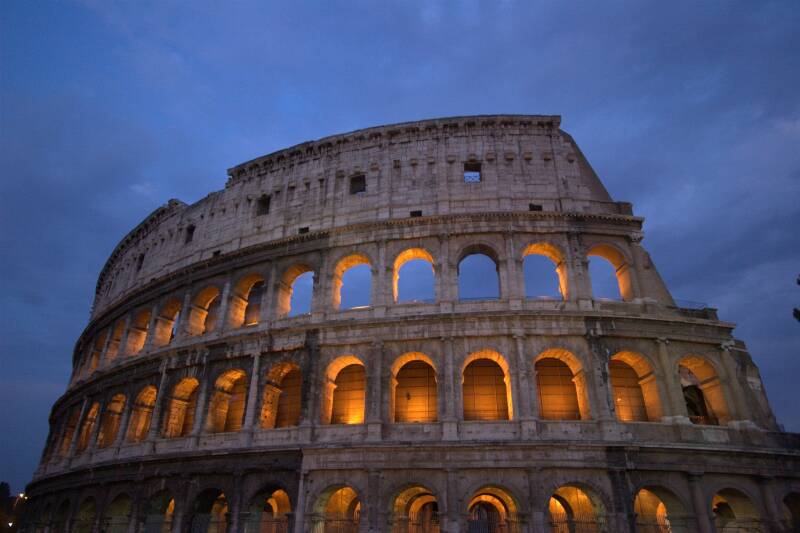The Coliseum in Rome at night, lit from within