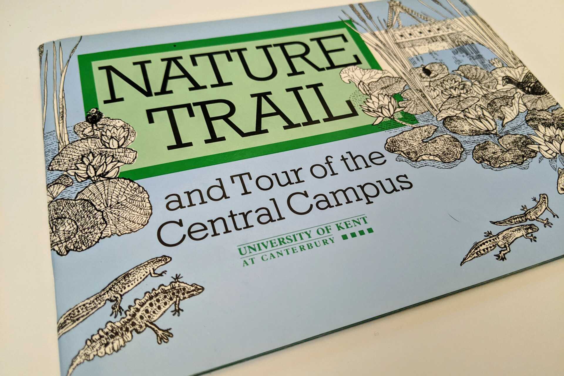 A close up of an old nature trail guide
