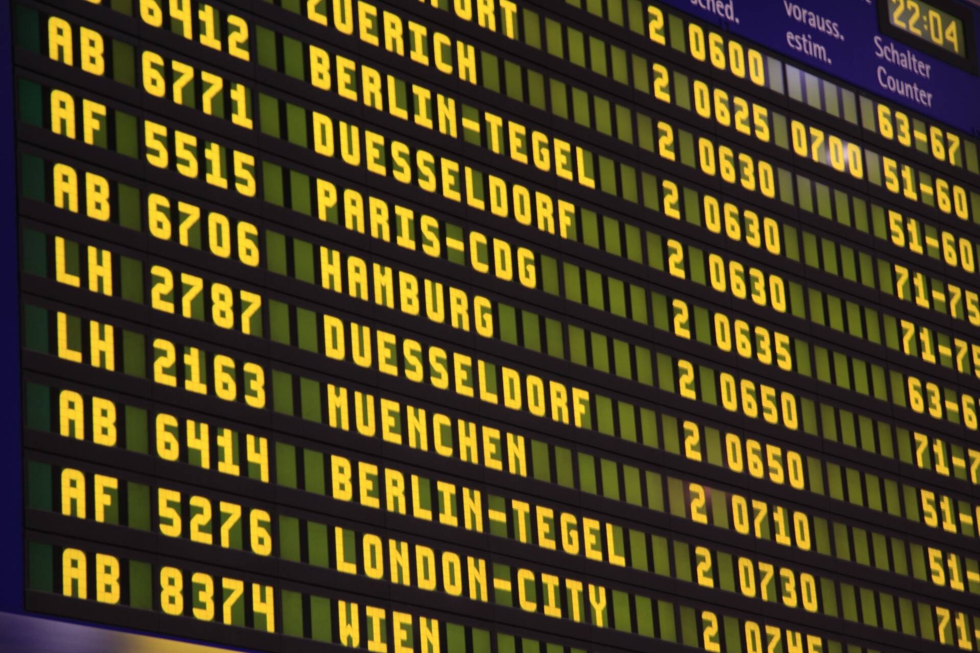 Airport arrivals board showing flights from Zurich, Berlin, Dusseldorf and Paris