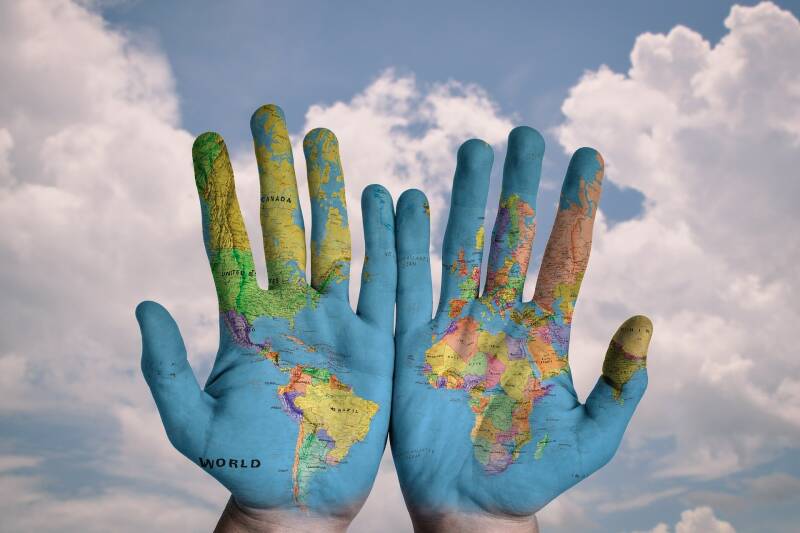 Hands painted with world map