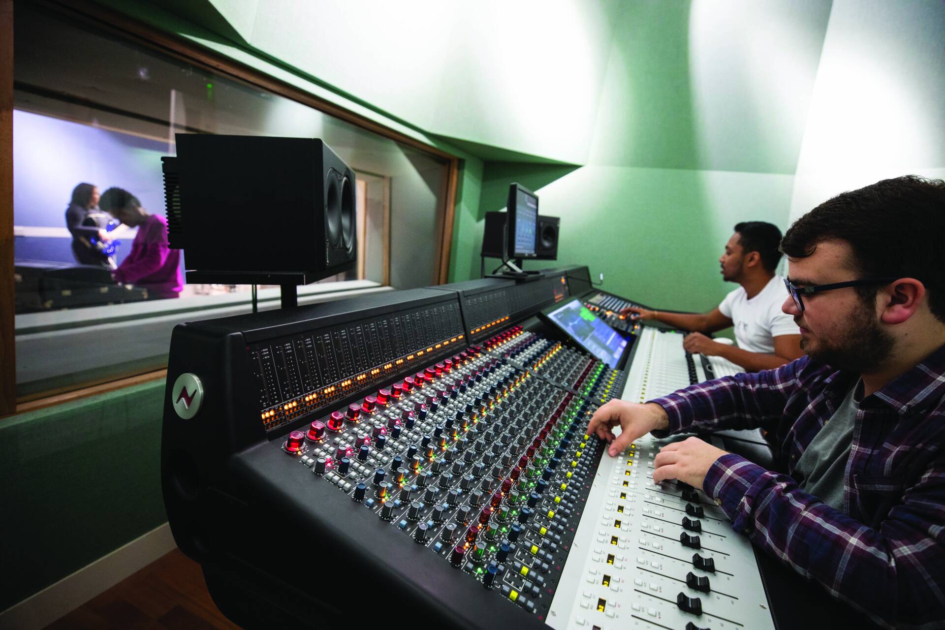 two students using the Neve Genesys console.