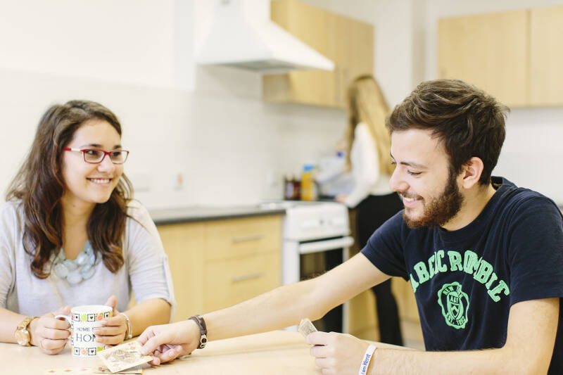 Two students talking in a phase 1 kitchen.