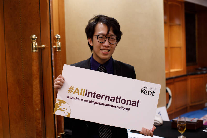 International student holding up #allinternational sign