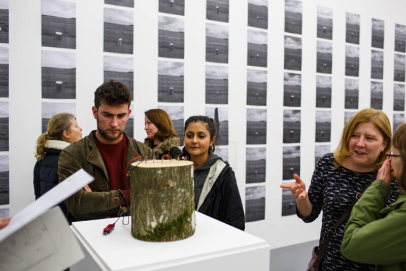 People look at an exhibit in Studio 3 Gallery