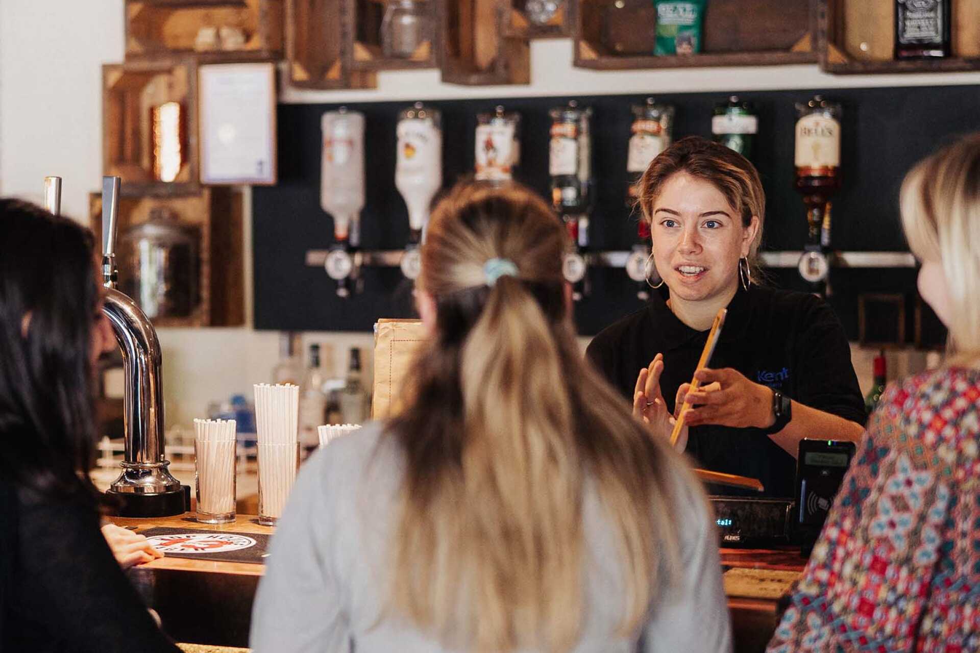 Customer being served coffee and pastry