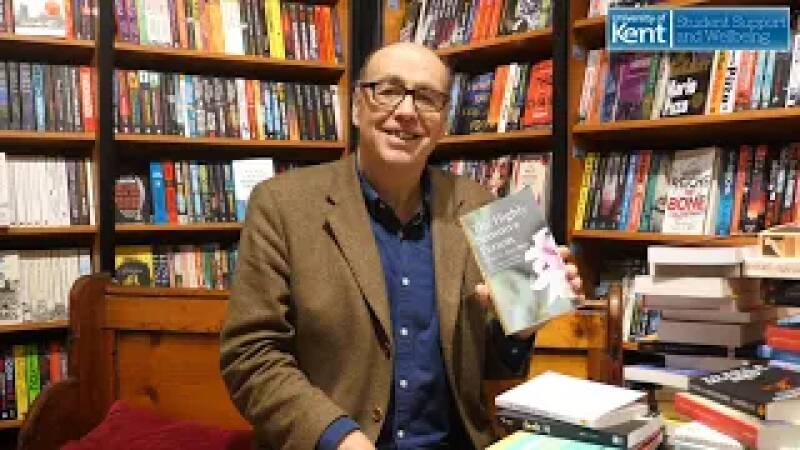 Bookseller holding self help book