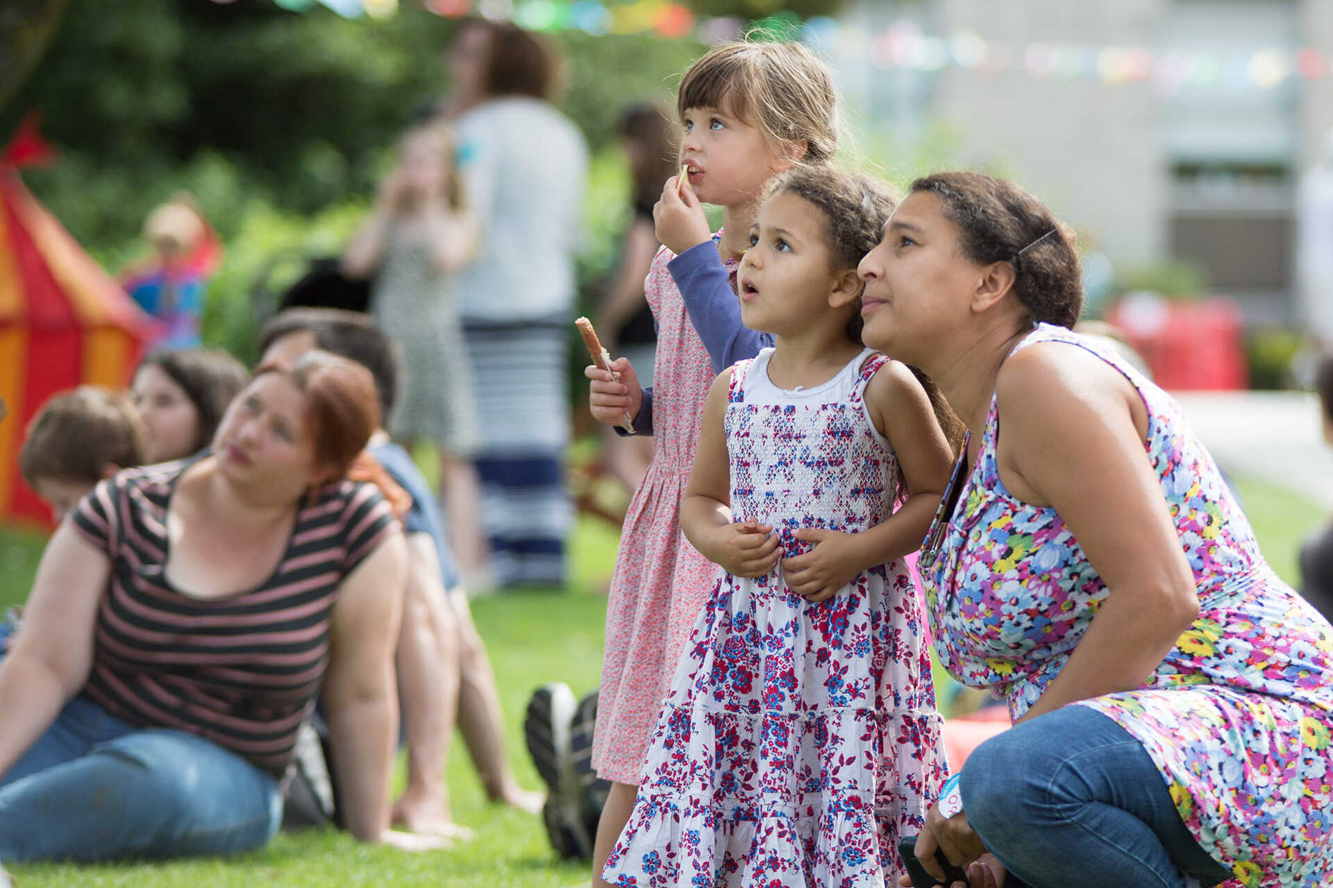 A woman and two children watching a performance at the BOing festival