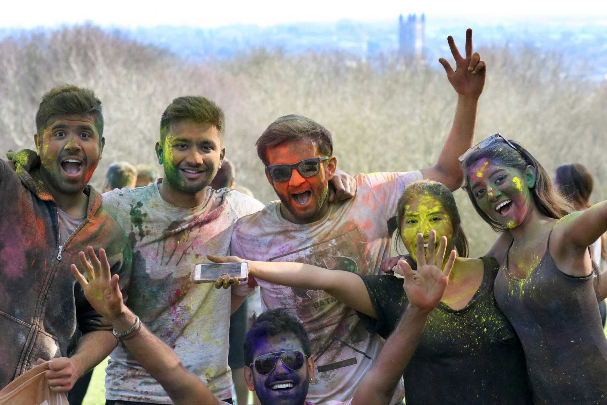 Group of students covered in paint to celebrate Holi Festival
