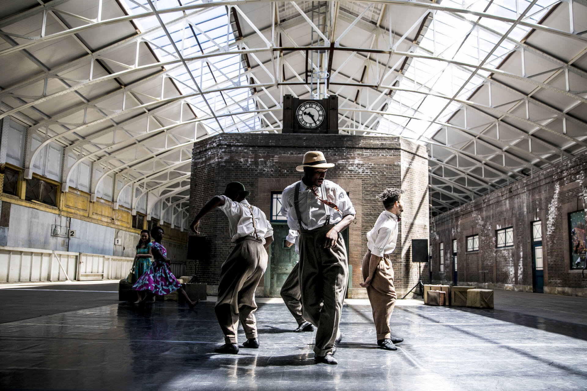 Dancers in a sunlit hangar