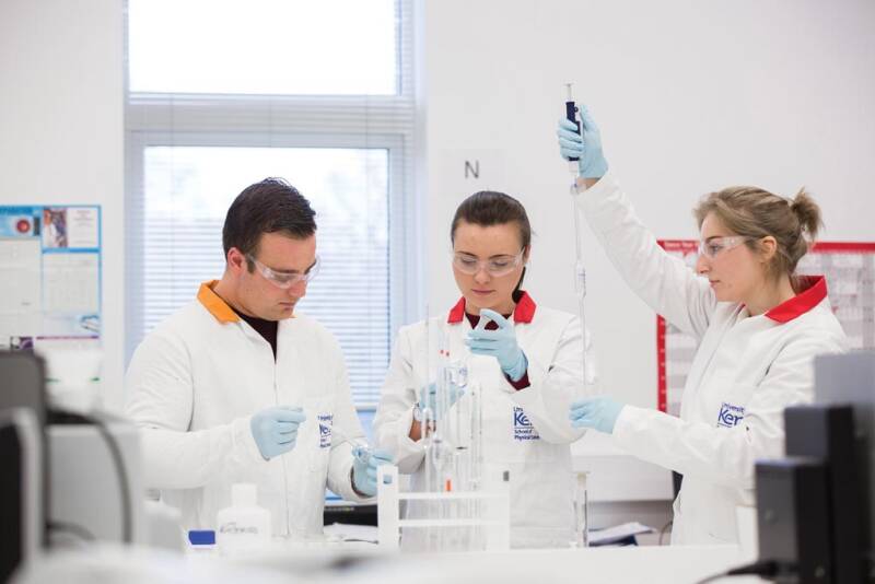 Three science students working in a lab