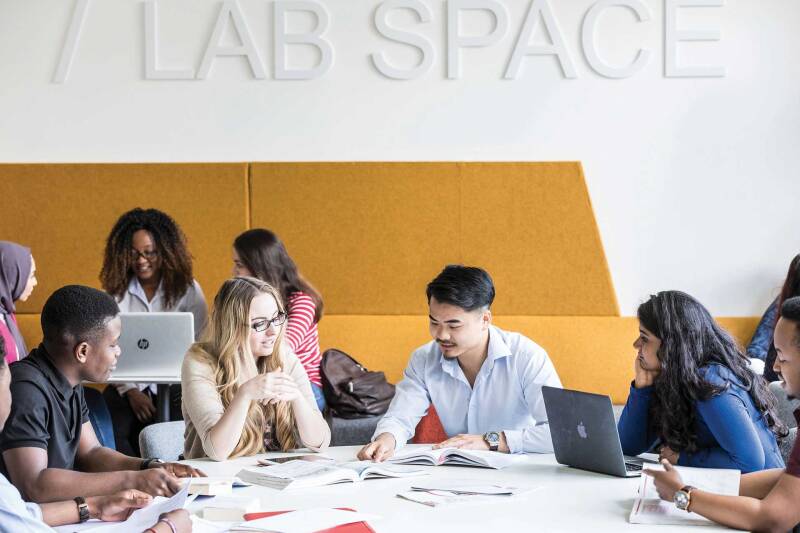 A group of students working in the ASPIRE lab space