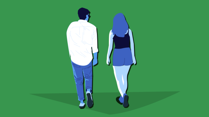Two people walking and talking.