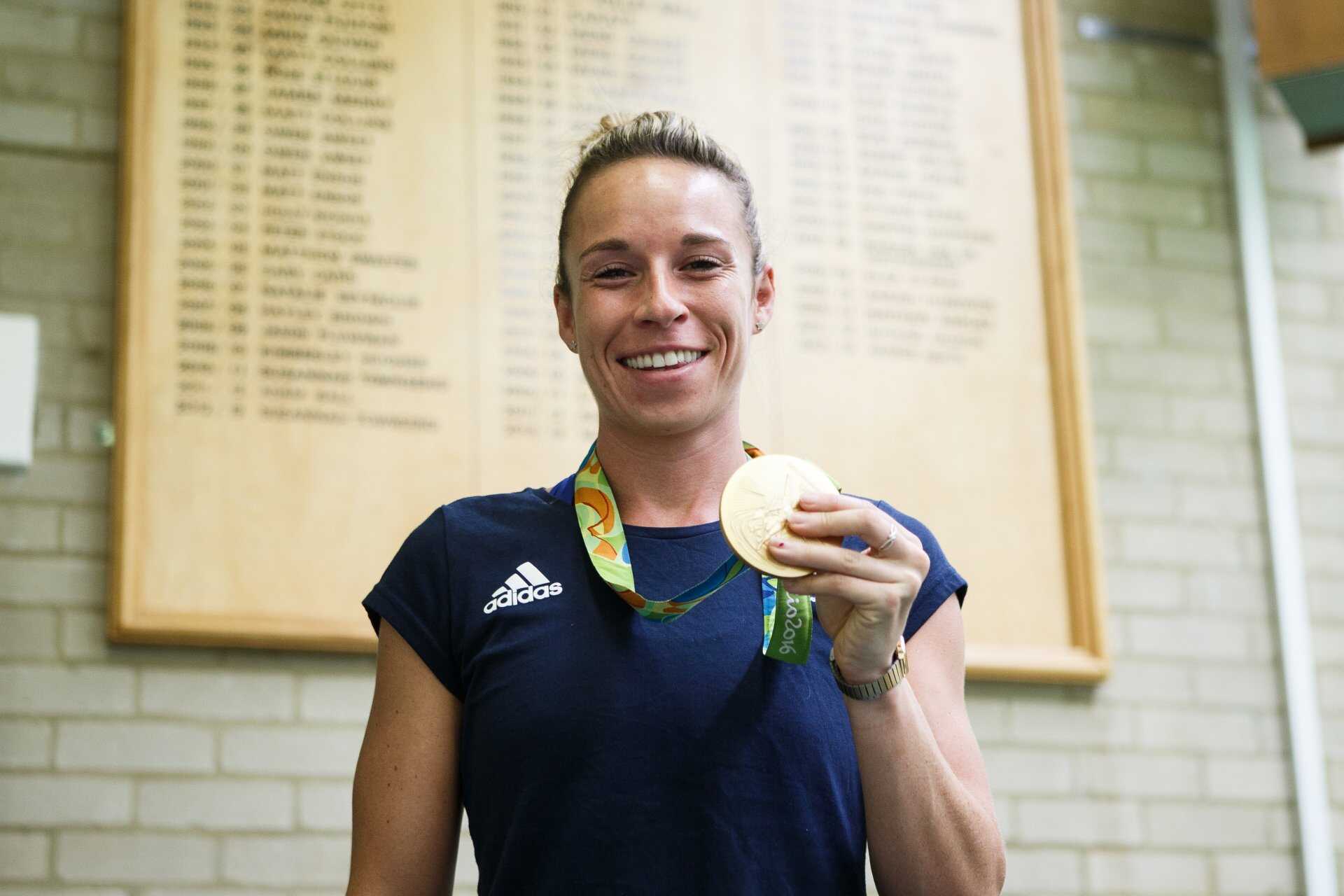 Susannah Townsend stood near the roll of honour in the Kent Sports Centre, holding her gold medal
