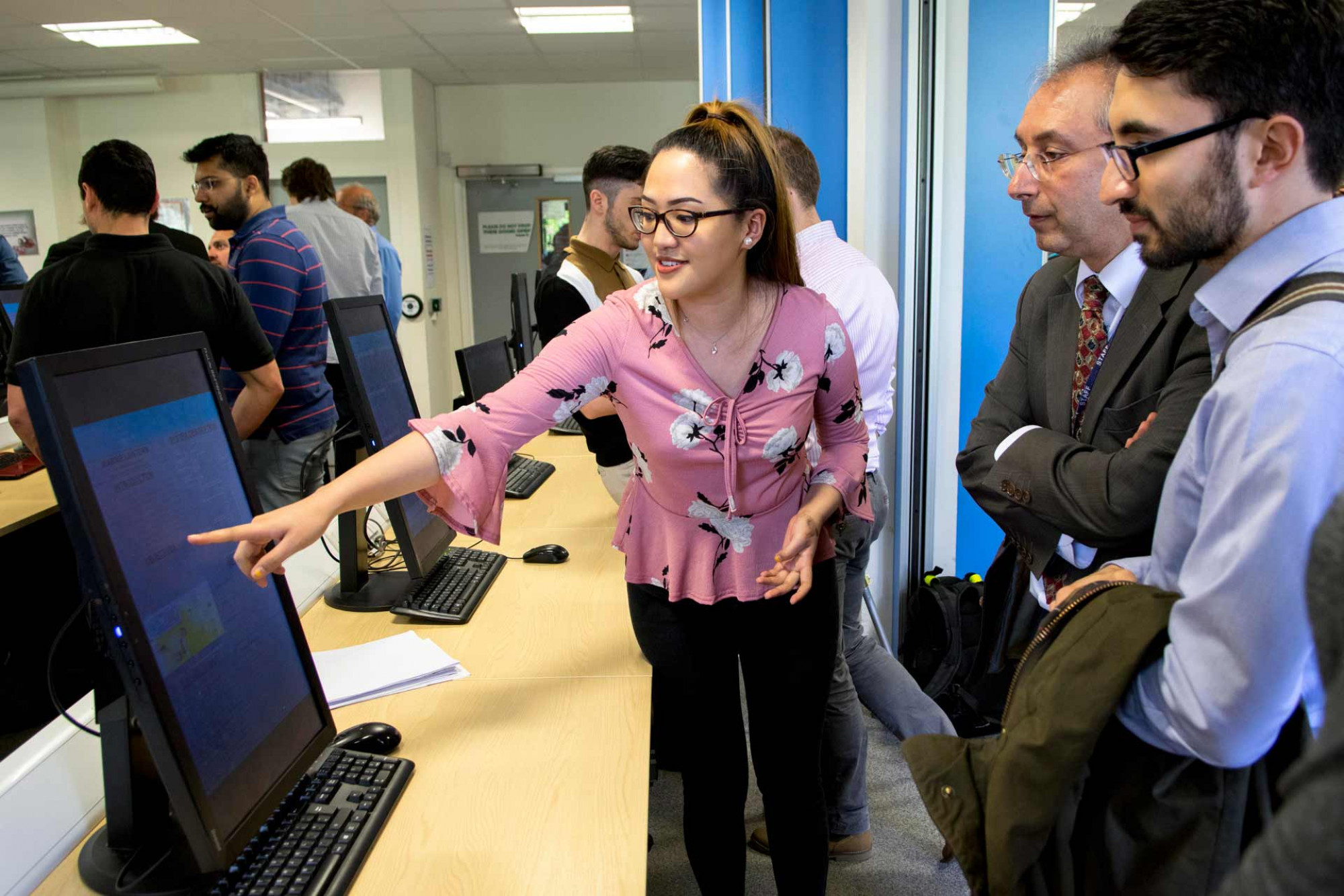 Three people look at a computer screen at the Careers and Employability Fair