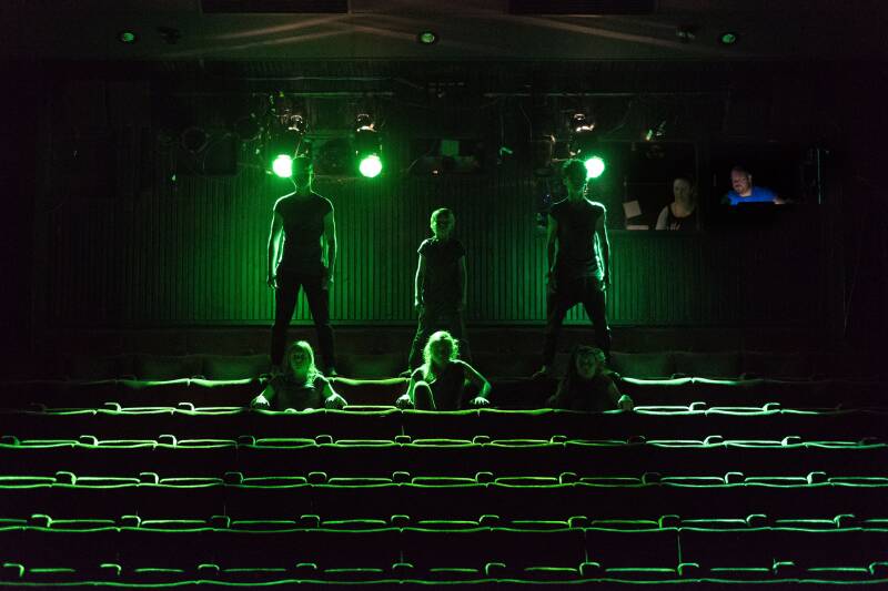 young people in a darkened theatre