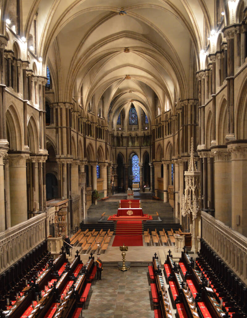 A photo looking down the Quire of Canterbury Cathedral, choir-stalls to the left and right
