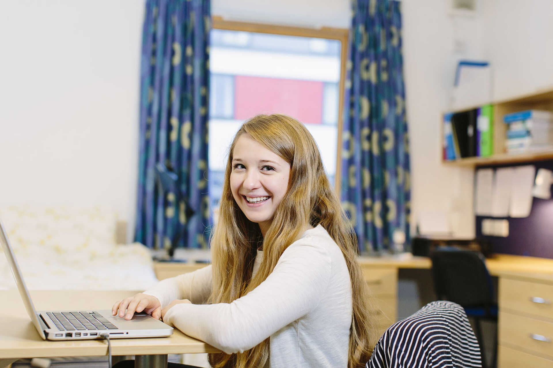 Female student working at a desk in Pier Quays