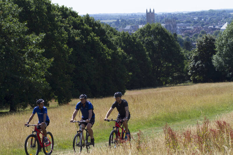 Cyclists on campus with Cathedral in background