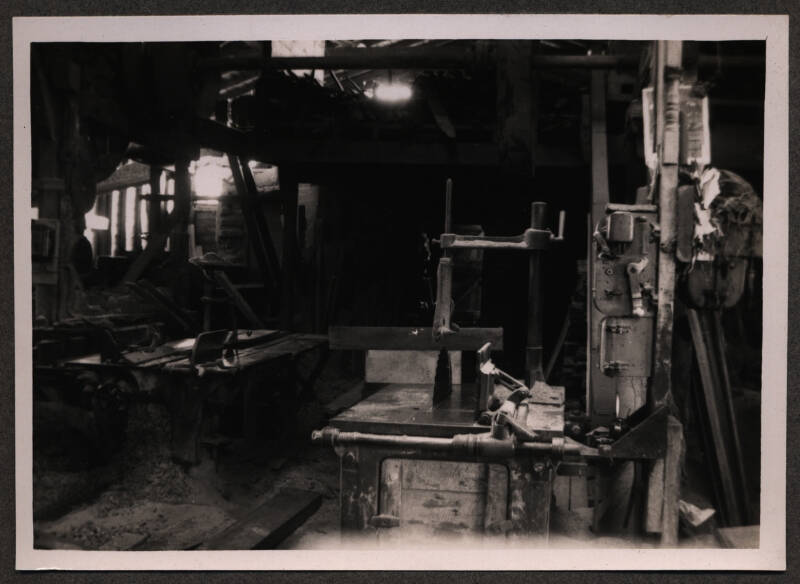 Black and white photograph of the inside of a mill.