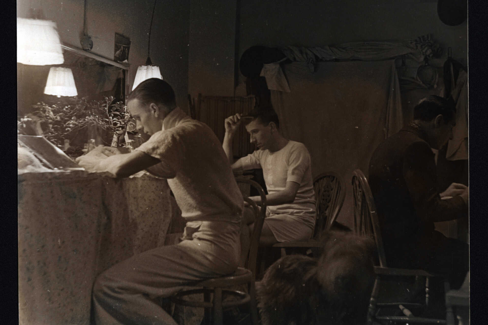 A black and white photograph of Eric Barker and others in the dressing room of the Windmill Theatre, 1935.