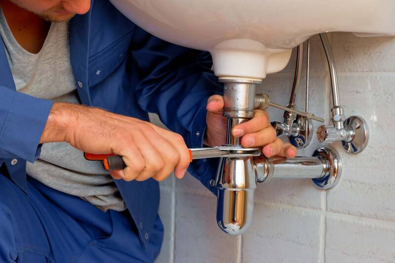 Sink being fixed by plumber