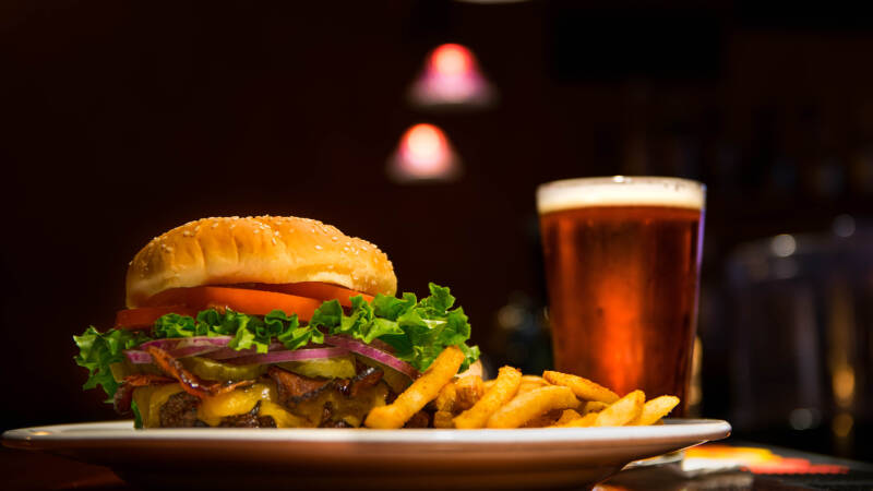 Close up of burger, fries and beer.