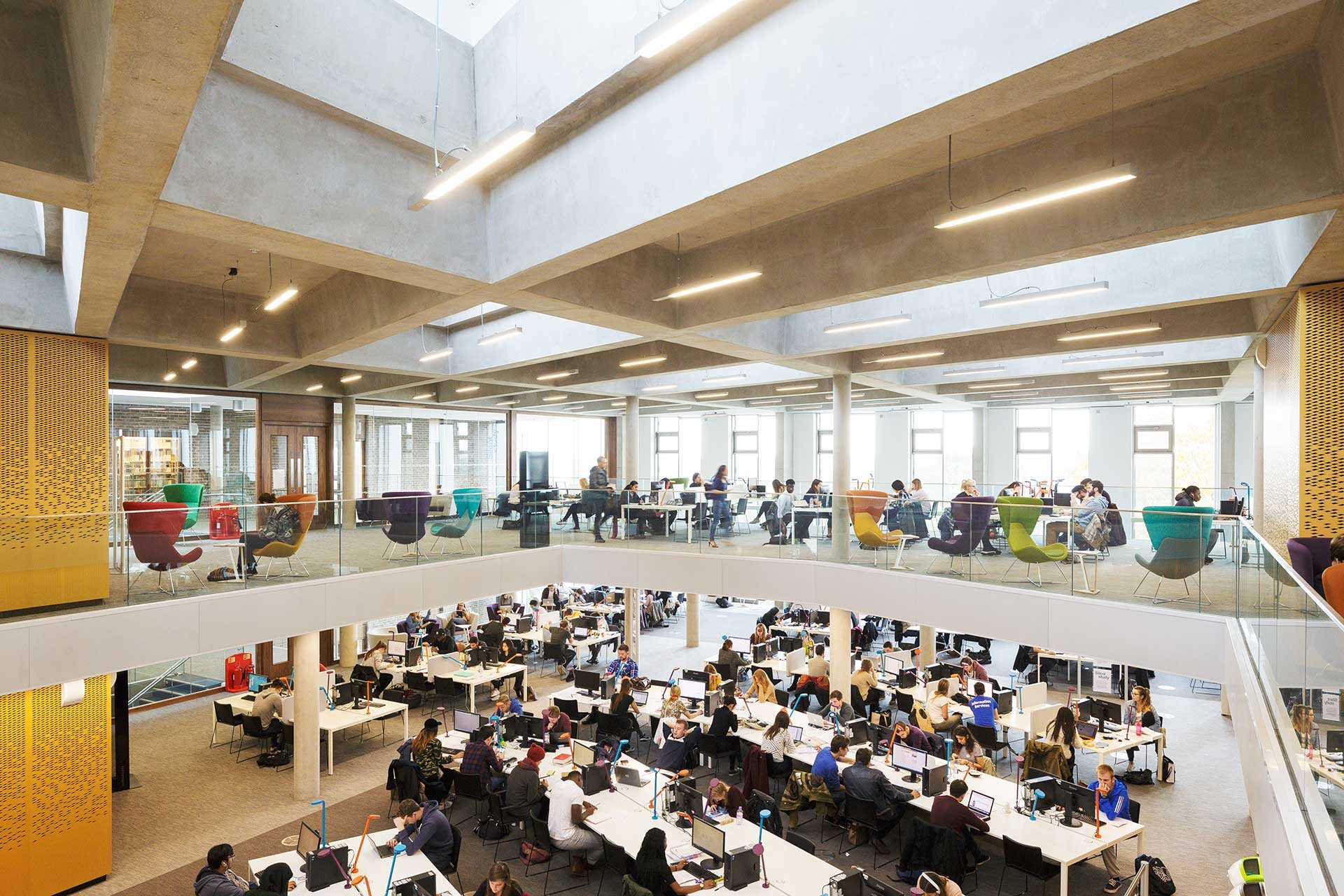 Students relaxing around the tables inside the Templeman Library