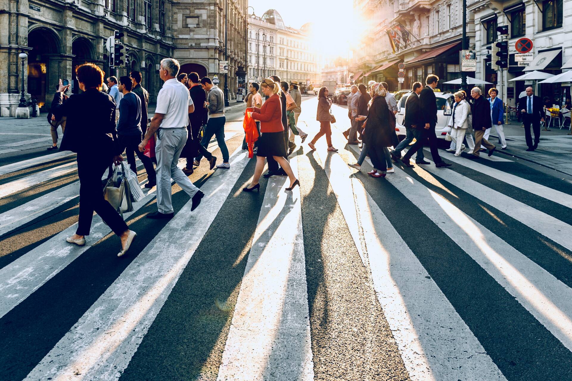 People crossing a busy urban street