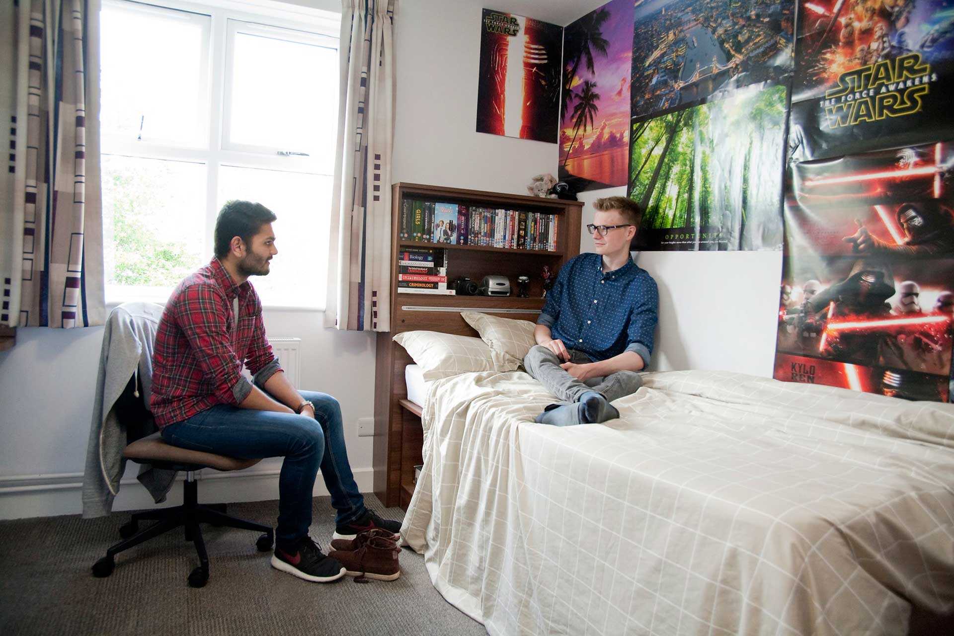 Students chat in a Becket Court bedroom