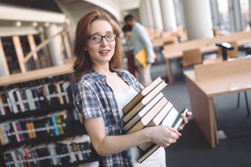 Student holding stack of books